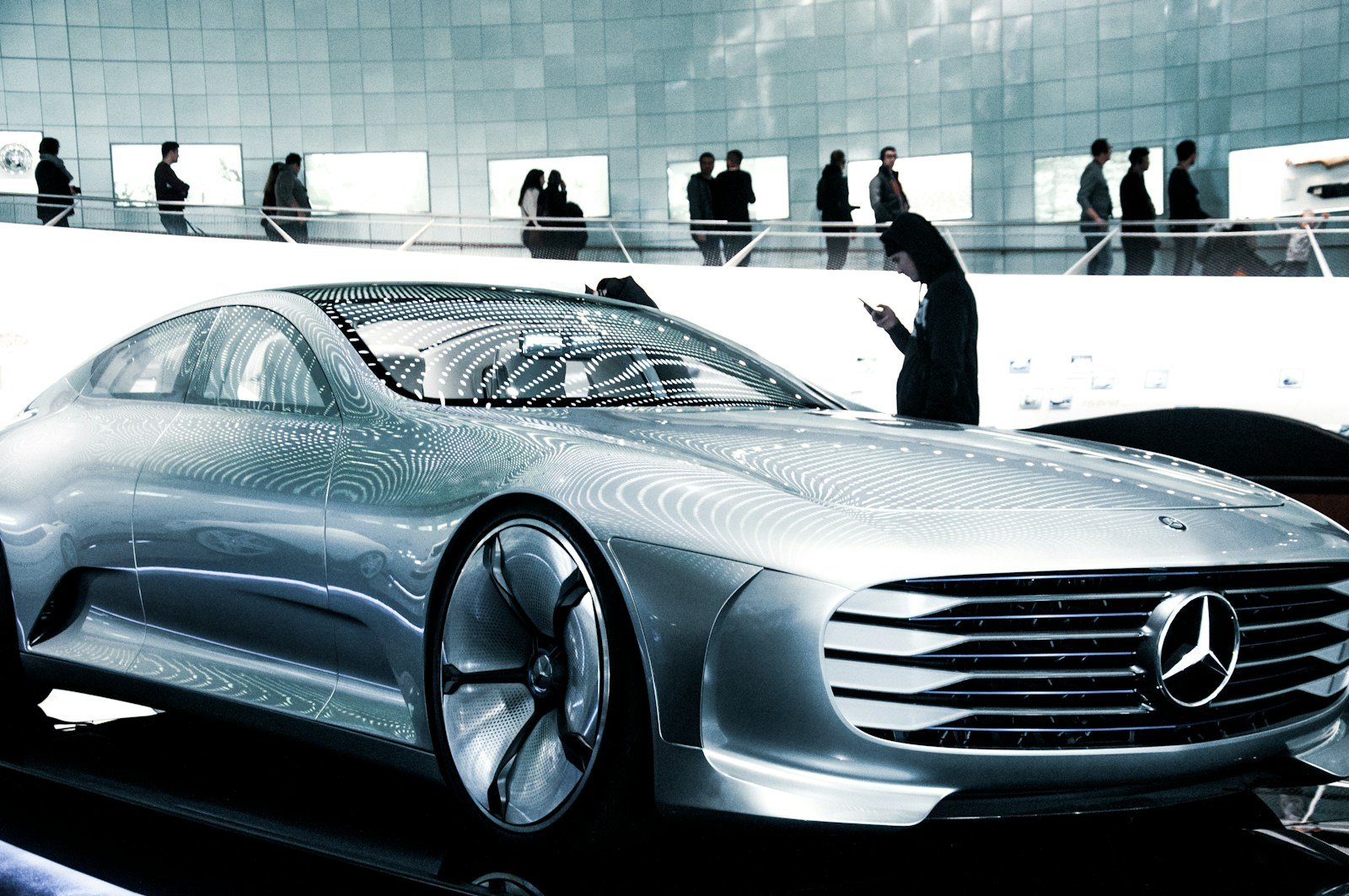 man in black suit standing beside silver mercedes benz coupe